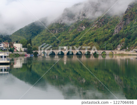 Bridge on the river Drina with a cloud covering mountains below the bridge Bridge on the river Drina with a cloud covering mountains below the bridge 122706698