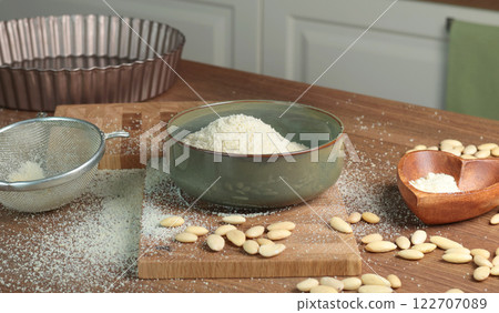 Almond flour in bowl. Nuts on table. Healthy food and products. Organic ingredients and vegan nutrition. Almond flour in bowl. Nuts on table. Healthy food and products. Organic ingredients and vegan nutrition. 122707089