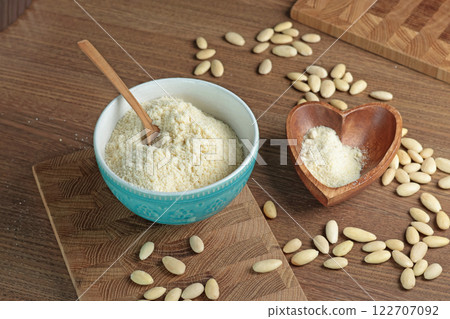 Almond flour in bowl. Nuts on table. Healthy food and products. Organic ingredients and vegan nutrition. Almond flour in bowl. Nuts on table. Healthy food and products. Organic ingredients and vegan nutrition. 122707092