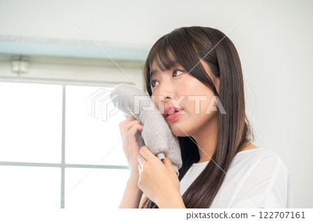Japanese woman wiping her face with a towel Japanese woman wiping her face with a towel 122707161