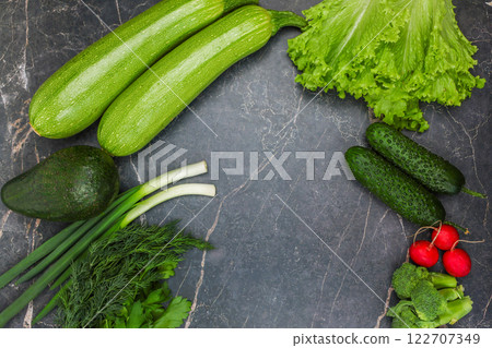 Vegetables, root vegetables and herbs lie against a background of dark marble around the edges with space for text in the center. The concept of cooking, proper nutrition, diet, and detox. High Vegetables, root vegetables and herbs lie against a background of dark marble around the edges with space for text in the center. The concept of cooking, proper nutrition, diet, and detox. High 122707349