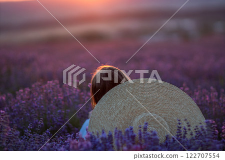 Lavender Fields Sunset Girl: Woman enjoys serene sunset amidst Provence lavender fields, summer, peaceful escape. 122707554