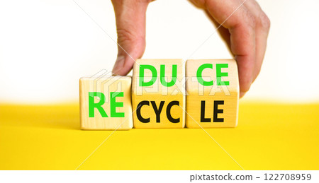 Reduce or recycle symbol. Concept words Reduce Recycle on wooden block. Beautiful yellow table white background. Businessman hand. Business reduce or recycle concept. Copy space. Reduce or recycle symbol. Concept words Reduce Recycle on wooden block. Beautiful yellow table white background. Businessman hand. Business reduce or recycle concept. Copy space. 122708959