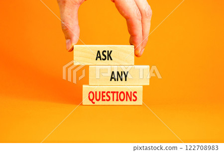 Ask any questions symbol. Concept words Ask any questions on beautiful wooden blocks. Beautiful orange background. Businessman hand. Business ask any questions concept. Copy space. 122708983