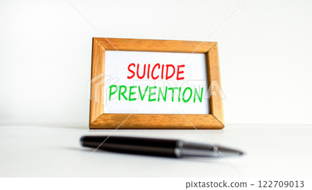 Suicide prevention symbol. Concept words Suicide prevention on beautiful wooden picture frame. Black pen. Beautiful white background. Psychological suicide prevention concept Copy space Suicide prevention symbol. Concept words Suicide prevention on beautiful wooden picture frame. Black pen. Beautiful white background. Psychological suicide prevention concept Copy space 122709013