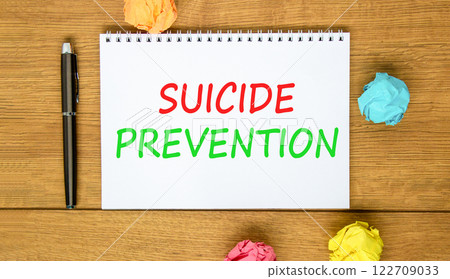 Suicide prevention symbol. Concept words Suicide prevention on beautiful white note. Beautiful wooden table wooden background. Black pen. Psychological suicide prevention concept. Copy space. Suicide prevention symbol. Concept words Suicide prevention on beautiful white note. Beautiful wooden table wooden background. Black pen. Psychological suicide prevention concept. Copy space. 122709033