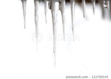 Icicles on a blue background - selective focusq copy space Icicles on a blue background - selective focusq copy space 122709145