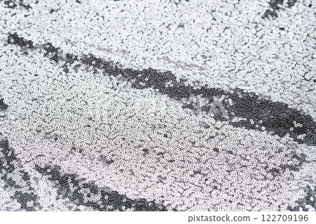 Abstract festive fabric texture with silver sequins. Abstract festive fabric texture with silver sequins. 122709196