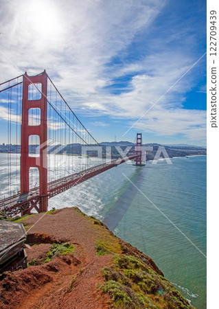 Golden Gate Bridge with blue sky and scenic ocean view from a high vantage point 122709439