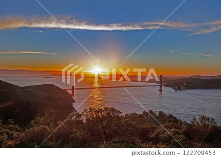 Golden Gate Bridge at sunset with San Francisco skyline in the background 122709453
