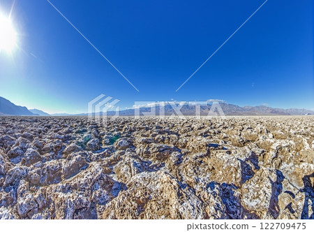 Rugged salt formations of Devils Golf Course under a bright blue sky 122709475