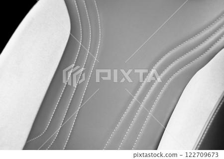Car  leather interior. Part of leather car seat details with white stitching. Interior of prestige car. Perforated leather seats isolated. Perforated leather. 122709673