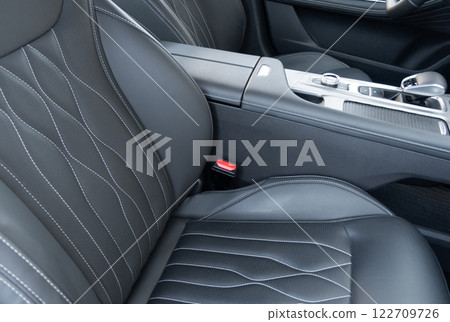 Modern luxury car black leather interior. Part of black leather car seat details with white stitching. Interior of prestige car. Comfortable perforated leather seats. Perforated leather. Modern luxury car black leather interior. Part of black leather car seat details with white stitching. Interior of prestige car. Comfortable perforated leather seats. Perforated leather. 122709726