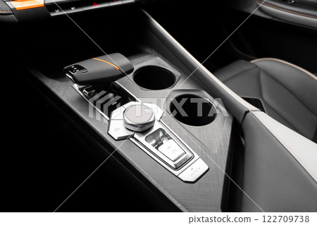Automatic gear in car. Modern car interior details. Close up view. Automatic transmission lever shift. Black leather interior with stitching Automatic gear in car. Modern car interior details. Close up view. Automatic transmission lever shift. Black leather interior with stitching 122709738