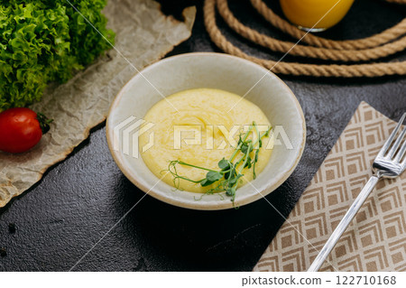 Creamy mashed potatoes garnished with fresh microgreens, in stylish and elegant food presentation Creamy mashed potatoes garnished with fresh microgreens, in stylish and elegant food presentation 122710168