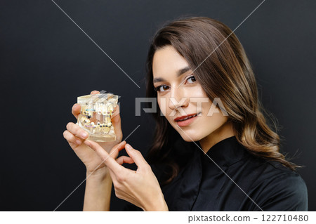 Orthopedic dentist doctor is holding teeth 3d printed model of the patient's jaw with malocclusion 122710480