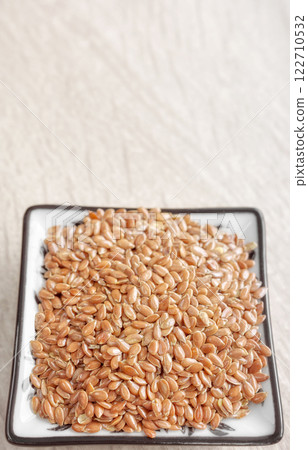 Close up photo of flax seeds, selective focus. Close up photo of flax seeds, selective focus. 122710532