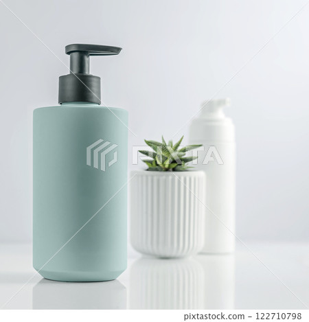 Blue Dispenser Bottle Filled with Essential Skincare Products 122710798