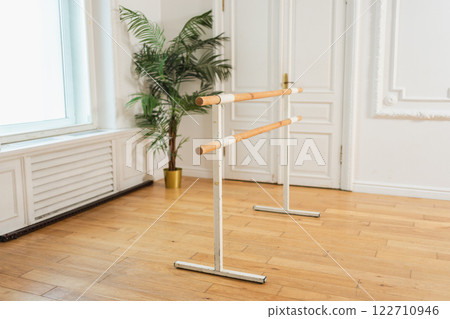 Empty ballet dance studio with barre. Professional ballet barre for stretching practicing dancing positions in dance school Dance hall ready for ballet class training. Ballet school 122710946
