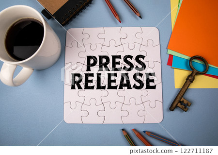 Press Release. White puzzle and office supplies on table Press Release. White puzzle and office supplies on table 122711187