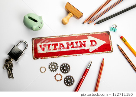 Vitamin D. Red direction arrow with text on white office desk Vitamin D. Red direction arrow with text on white office desk 122711190