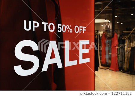 Red Sale Banner with Up to 50 pct Off Text. Bold Promotional Display in a Modern Store Red Sale Banner with Up to 50 pct Off Text. Bold Promotional Display in a Modern Store 122711192