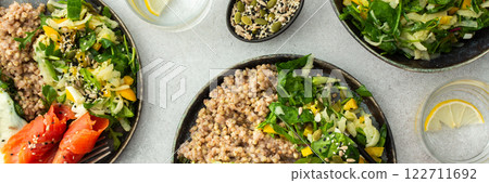 Buckwheat with fried egg and salmon fish, mix salad with fresh herbs and peppers 122711692