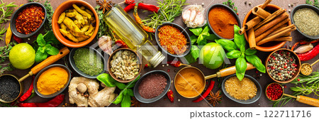 A rich palette of colorful spices and herbs, resting on a brown background, radiating freshness and an inviting aroma, perfect for gourmet inspiration, banner A rich palette of colorful spices and herbs, resting on a brown background, radiating freshness and an inviting aroma, perfect for gourmet inspiration, banner 122711716