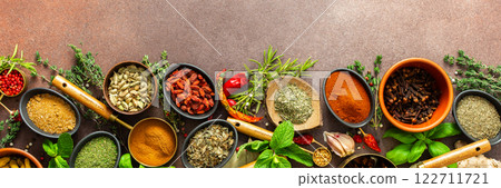 A rich palette of colorful spices and herbs, resting on a brown background, radiating freshness and an inviting aroma, perfect for gourmet inspiration, banner A rich palette of colorful spices and herbs, resting on a brown background, radiating freshness and an inviting aroma, perfect for gourmet inspiration, banner 122711721