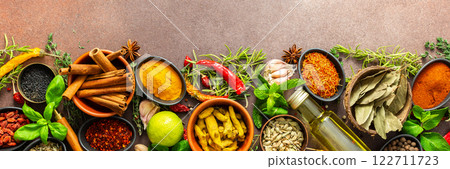A rich palette of colorful spices and herbs, resting on a brown background, radiating freshness and an inviting aroma, perfect for gourmet inspiration, banner A rich palette of colorful spices and herbs, resting on a brown background, radiating freshness and an inviting aroma, perfect for gourmet inspiration, banner 122711723