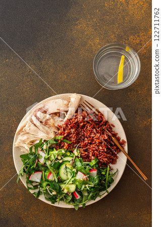Chicken breast with red rice and salad mix with seasonal organic vegetables Chicken breast with red rice and salad mix with seasonal organic vegetables 122711762