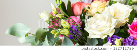 This seasonal bouquet of roses, eucalyptus, and eustoma in soft pink, white, and purple tones makes an ideal gift for anniversaries, birthdays, or any special event, banner 122711789