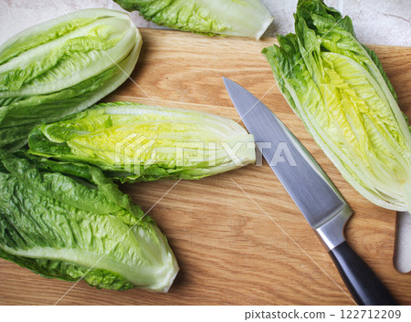 roman lettuce on cutting board roman lettuce on cutting board 122712209