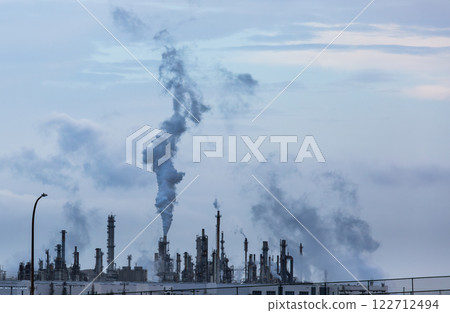 Working Industrial Plant with Smoke Stacks Billowing Smoke Into The Air. 122712494