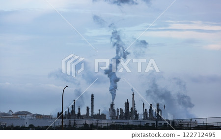 Working Industrial Plant with Smoke Stacks Billowing Smoke Into The Air. Working Industrial Plant with Smoke Stacks Billowing Smoke Into The Air. 122712495