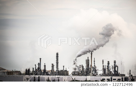 Working Industrial Plant with Smoke Stacks Billowing Smoke Into The Air. 122712496