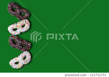 Flat lay of greeting card for carnival or birthday with cookies in the shape of a mask. 122712751