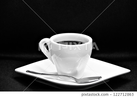 Cup of coffee on plate and spoon on black background Cup of coffee on plate and spoon on black background 122712863
