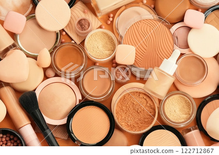 Varieties of face powders and foundations for perfect complexion, basic make up products to even out and matte skin, beauty cosmetics with brushes and sponges, selective focus Varieties of face powders and foundations for perfect complexion, basic make up products to even out and matte skin, beauty cosmetics with brushes and sponges, selective focus 122712867