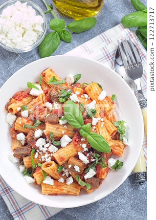 Rigatoni alla Norma pasta with eggplant, tomato, basil and ricotta salata, vertical top view Rigatoni alla Norma pasta with eggplant, tomato, basil and ricotta salata, vertical top view 122713717