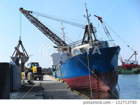 A small gutted ship unloading its cargo of gravel 122713780