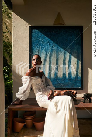 Androgynous person in white wedding dress, sunlit villa. Fluid identity. LGBTQ friendly bridal, inclusive style, gender-neutral attire. Luxury, art wall, modern design. Contemporary atmosphere. Androgynous person in white wedding dress, sunlit villa. Fluid identity. LGBTQ friendly bridal, inclusive style, gender-neutral attire. Luxury, art wall, modern design. Contemporary atmosphere. 122713918