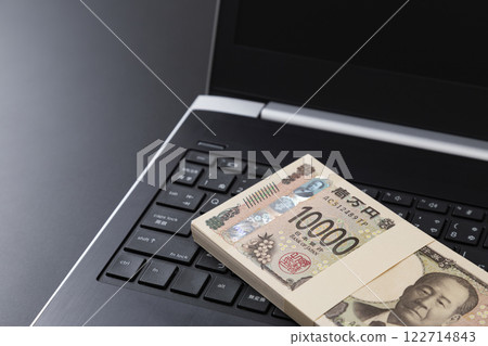 Laptop computer and money Laptop computer and money 122714843