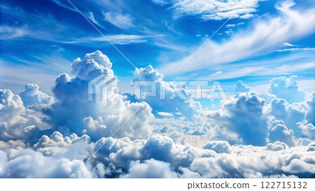 The image shows a breathtaking view of a vast, blue sky filled with fluffy white clouds, creating a serene and ethereal atmosphere. 122715132