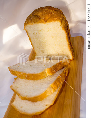 Fresh homemade bread on wooden cutting board. Fresh homemade bread on wooden cutting board. 122715211