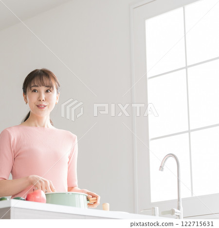 Housewife standing in the kitchen Housewife standing in the kitchen 122715631