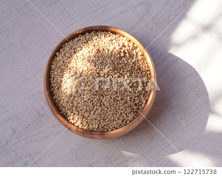 Top view of sesame in wooden bowl on white background. Copy space Top view of sesame in wooden bowl on white background. Copy space 122715738