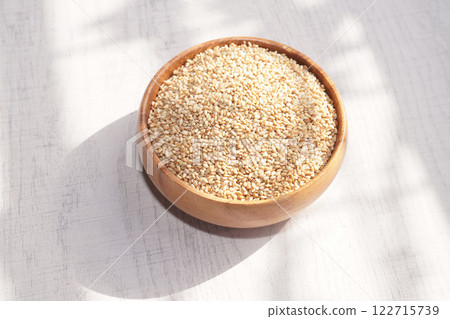 Top view of sesame in wooden bowl on white background. Copy space Top view of sesame in wooden bowl on white background. Copy space 122715739