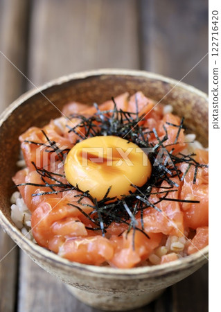 Salmon yukke rice bowl topped with egg yolk Salmon yukke rice bowl topped with egg yolk 122716420