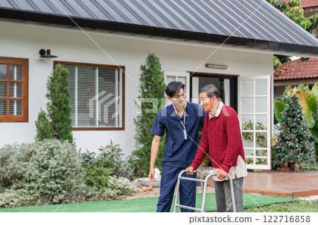 Nurse assisting elderly man with walker in a serene garden setting near a cozy home Nurse assisting elderly man with walker in a serene garden setting near a cozy home 122716858